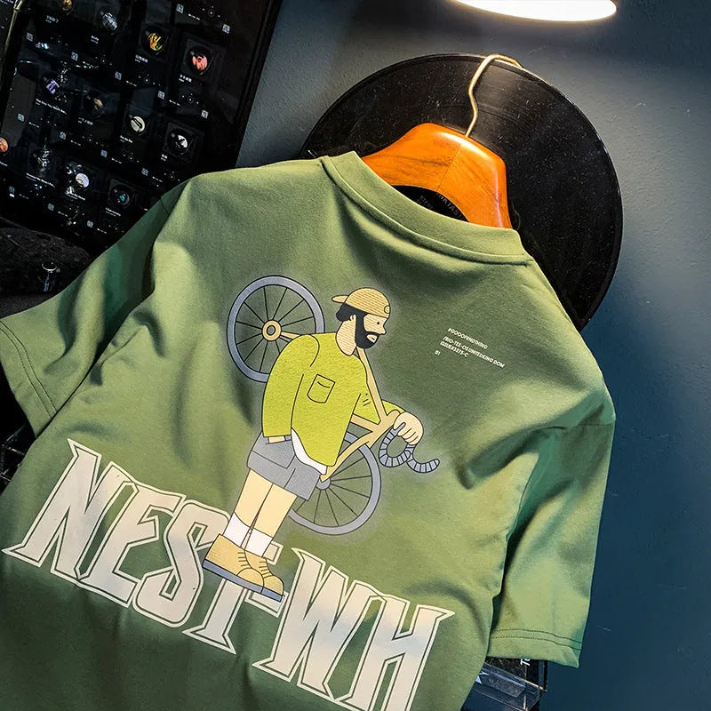 Green loose fit men's t-shirt with a front graphic print and short sleeves on a hanger.
