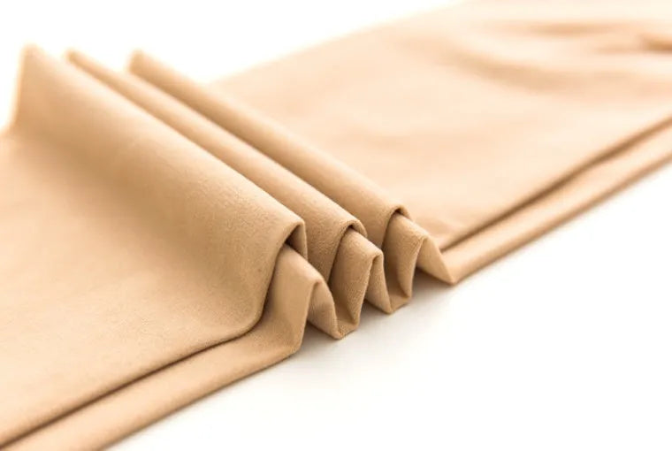 Beige and black stovepipe shapewear socks for lifting hips and abdomen on a plain background.