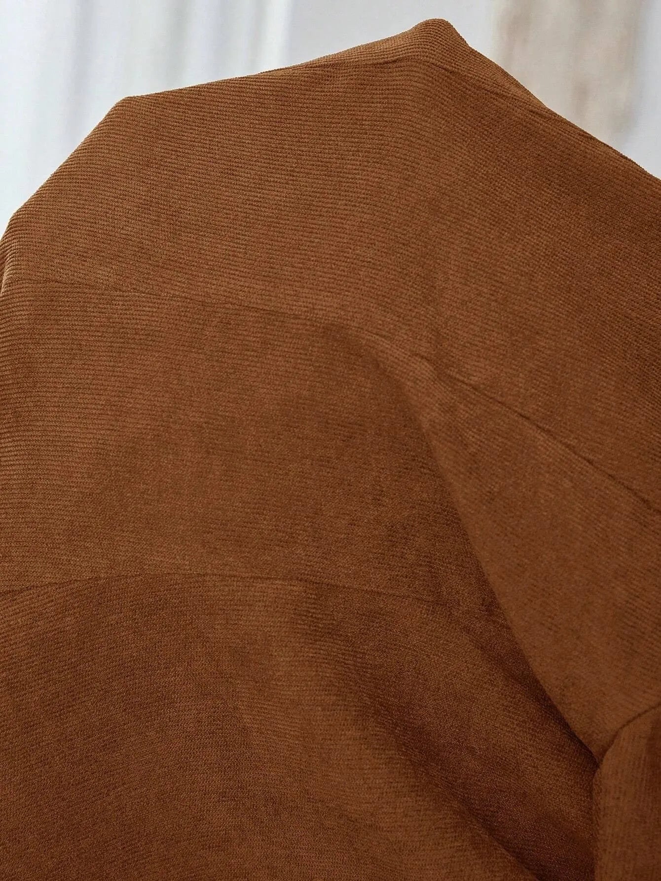 Brown lapel long sleeve single-breasted suit coat on a hanger
