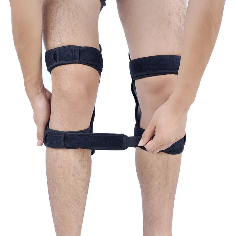 Black spring knee brace with adjustable straps on a grey background