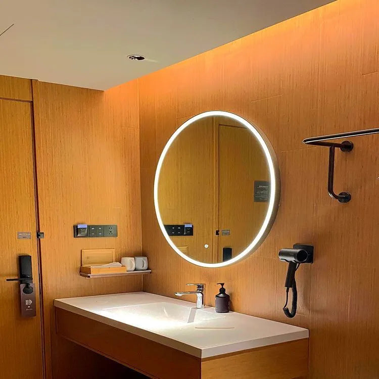 Round black aluminium frame LED bathroom mirror mounted on wall with dimmable lights on.