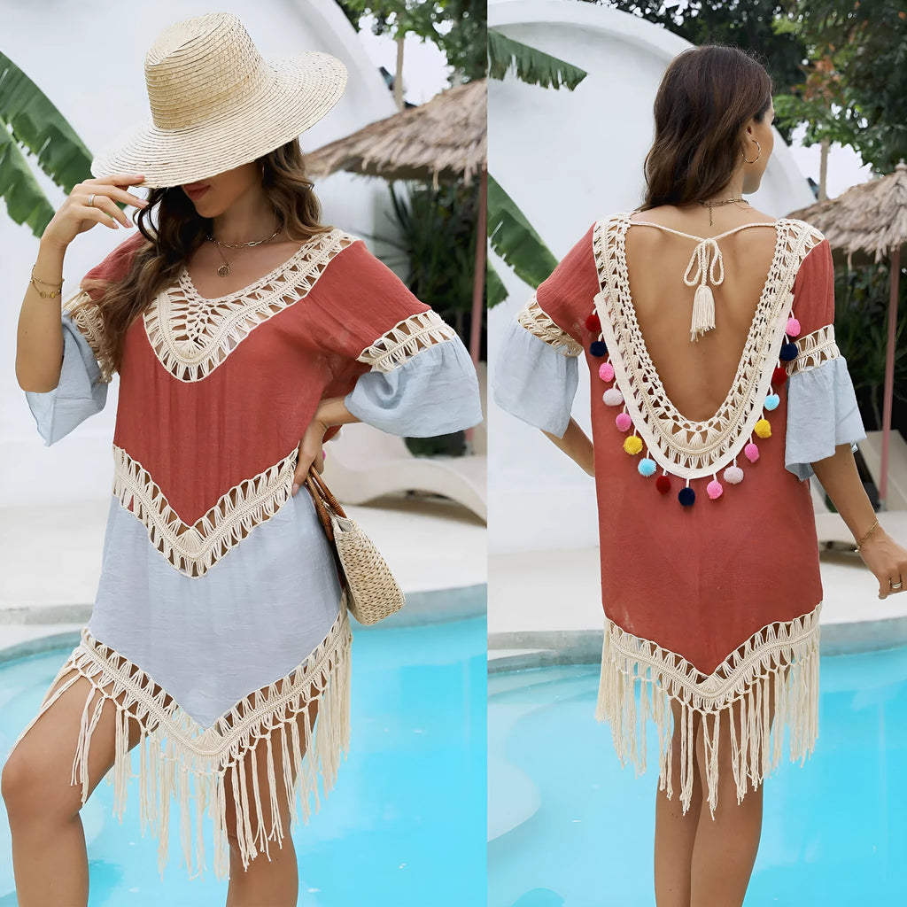 Orange floral pattern beach overskirt with hand crochet stitching and tassel details on a mannequin.