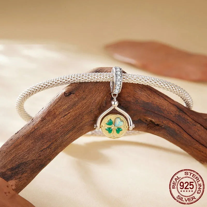 925 sterling silver rotating card pendant with four-leaf clover and wing detail on white background