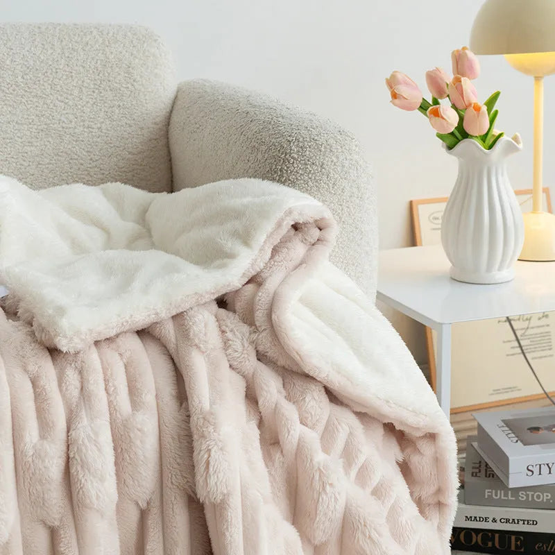 Rabbit Bejirog solid colour polyester fibre flange blanket on a bed, available in multiple sizes and colours