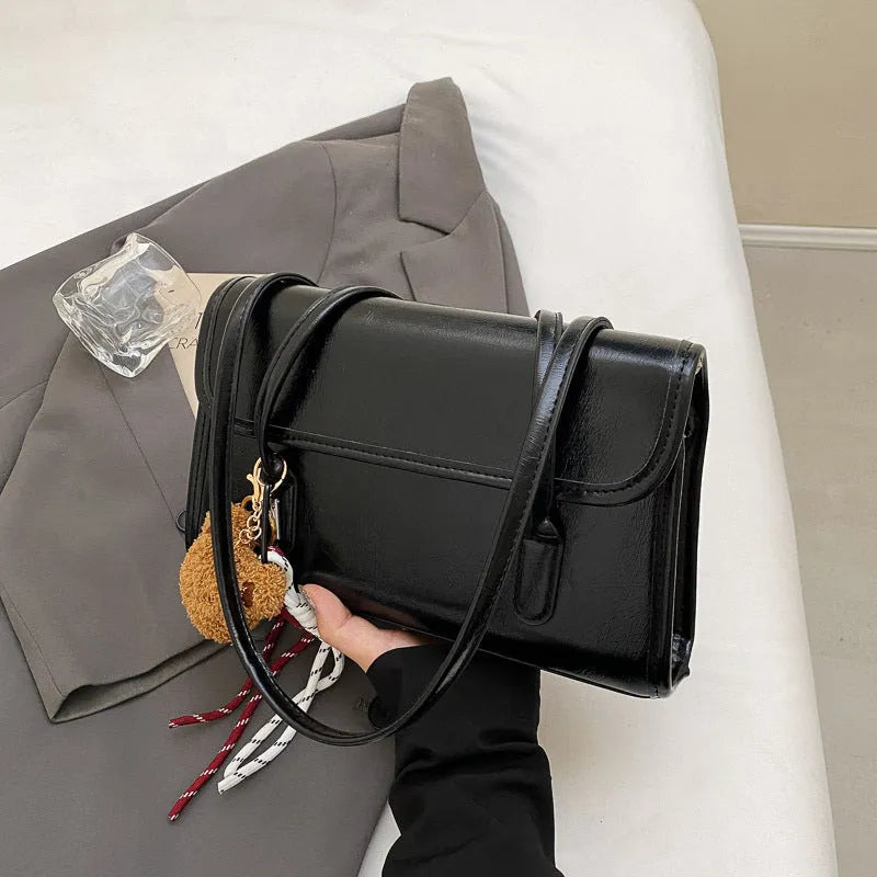 Women's brown PU leather shoulder bag with horizontal square shape and decorative pendant