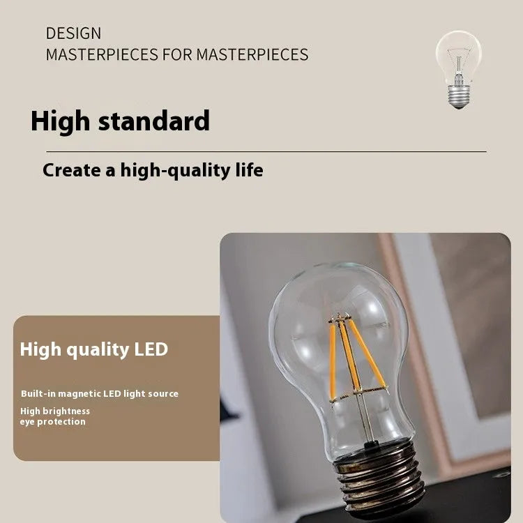 Iron art suspension bulb night lamp on a black wood grain base