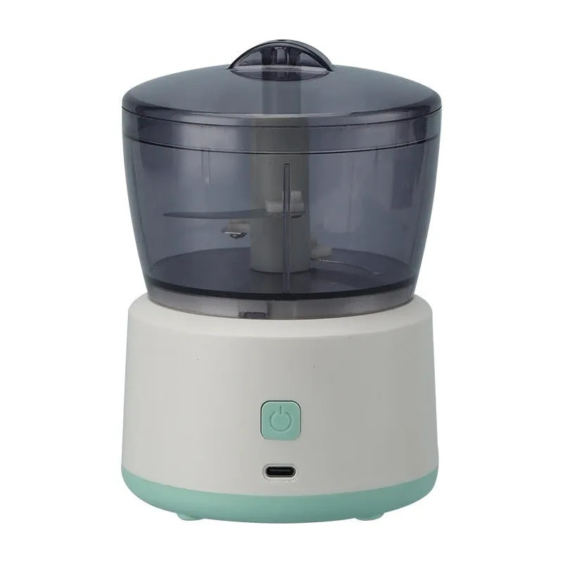 Mini electric meat grinder in light green with transparent cup and stainless steel blades