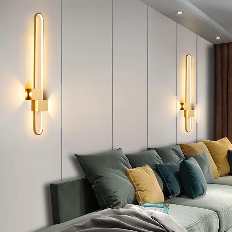 Round modern minimalist wall lamp with iron shade in black or gold finish.