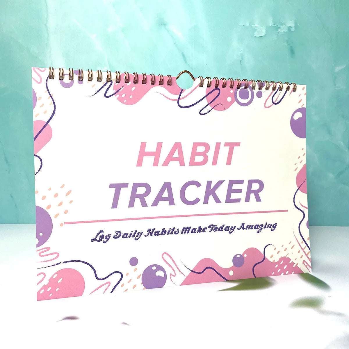 A4 habit tracking planner showing pink white cover with 12 internal pages for schedule recording