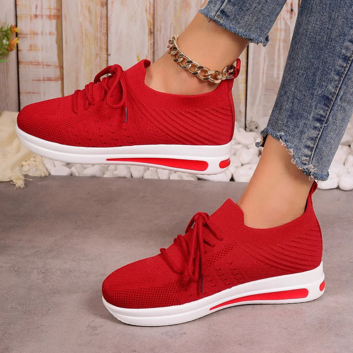 Women's black fly-knit casual sneakers with low-top design and round toe.