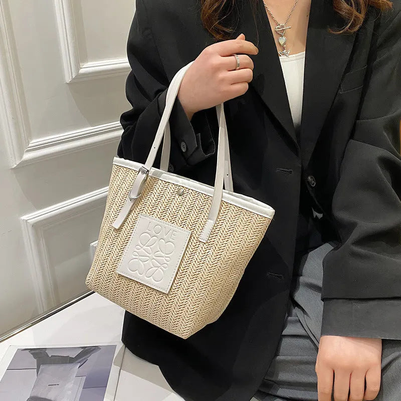 Straw woven women's shoulder bag in black with three-dimensional pocket and 27cm width