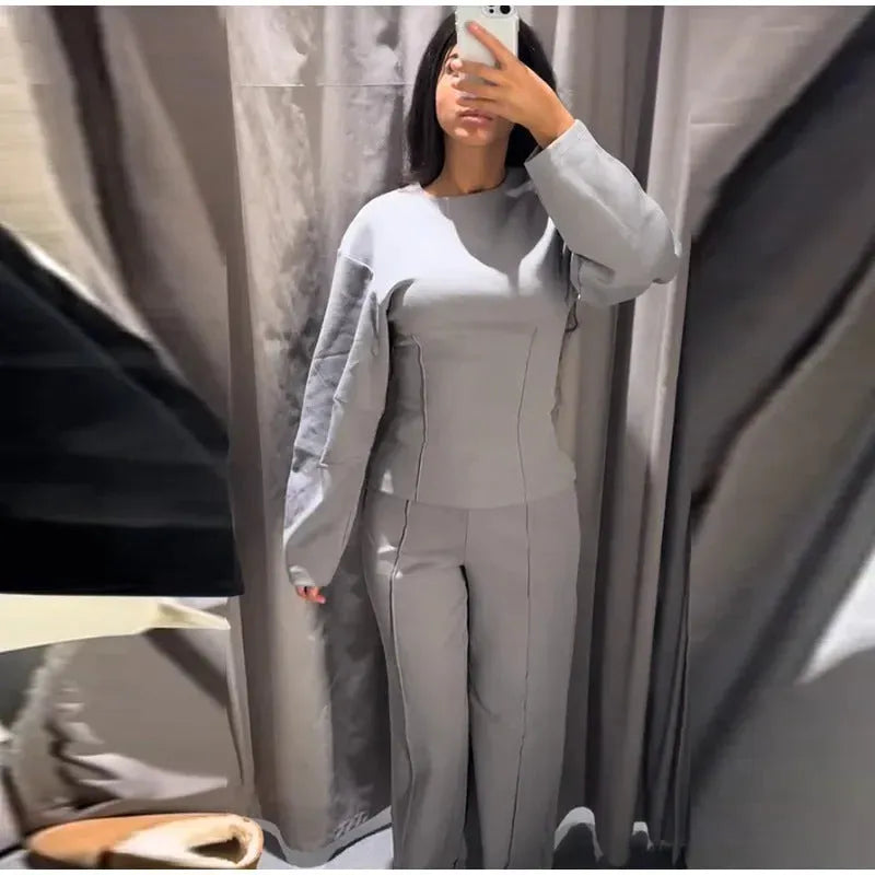 Women's black polar fleece suit set with pleated O-neck long sleeve top and wide leg trousers