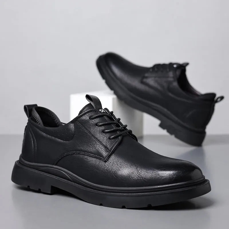 Men's black and brown leather casual sneakers with visible sewing line detail on the cowhide upper.