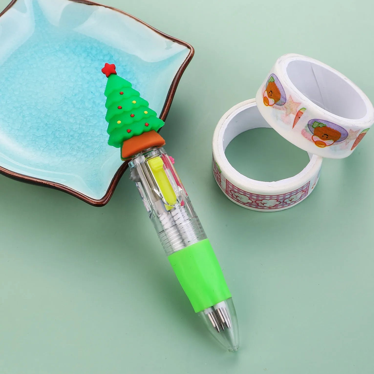 Christmas mini four-colour press-type ballpoint pen showing festive designs, 11cm long.