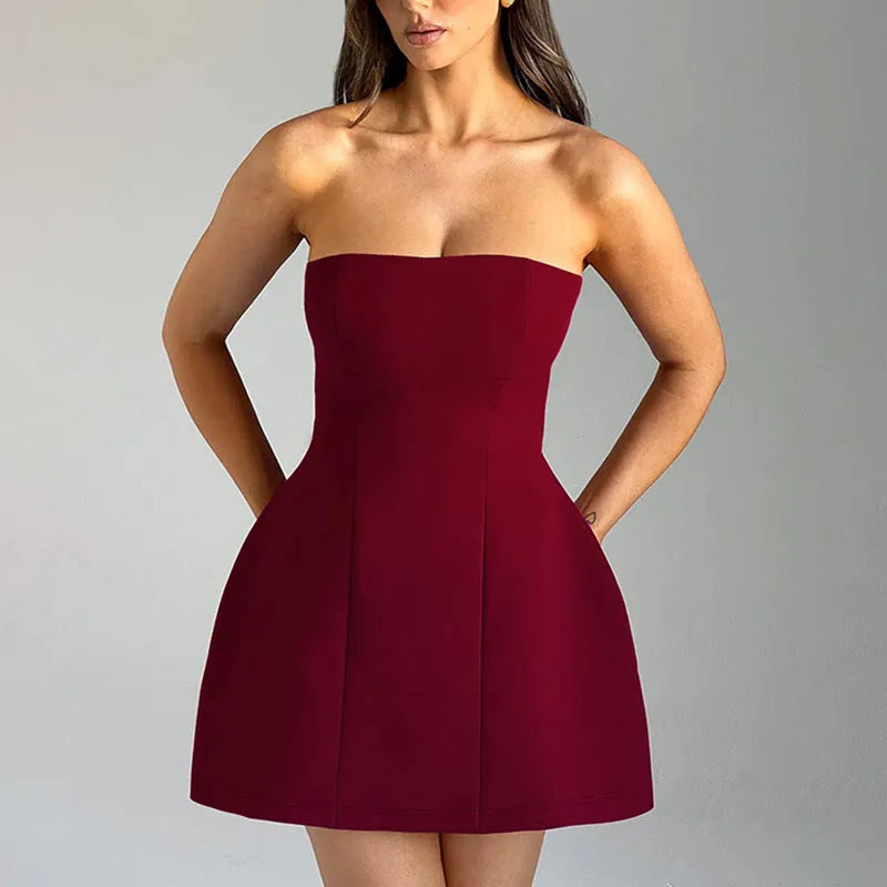 Women's solid colour backless tube dress with A-line skirt and high waist in various colours.