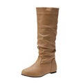 Women's flat black slip-on ankle boots with round toe and high shaft on a rubber sole.