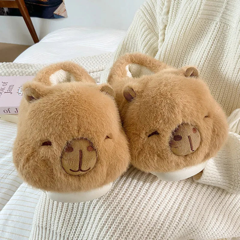Light brown women's winter plush slippers with a cartoon pattern, round toe, and a pull-on oversleeve design.