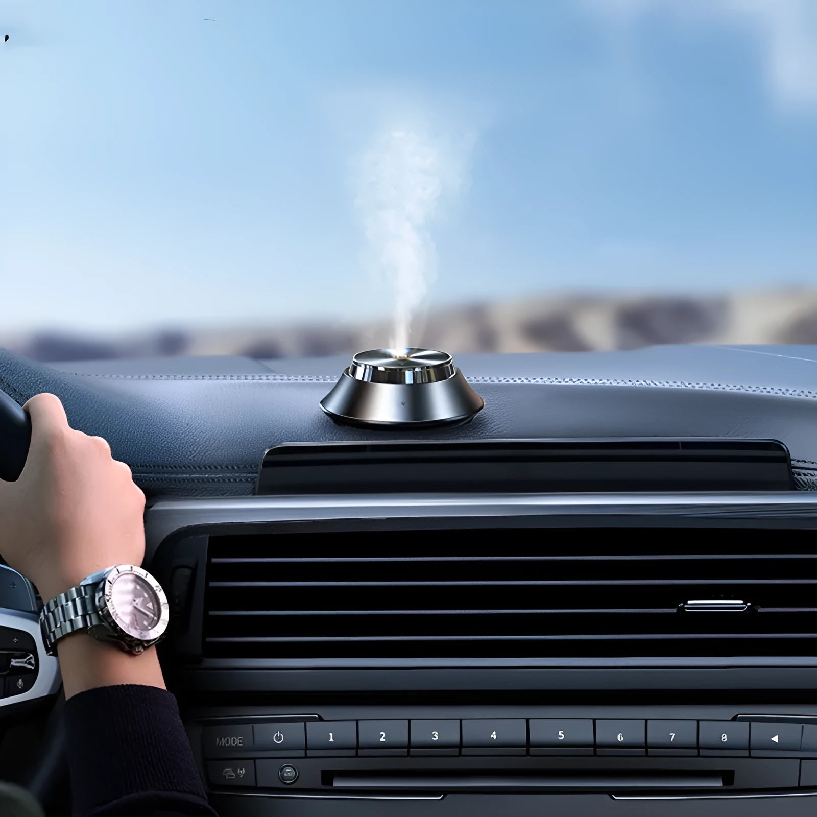 Black metal car air purifier with butterfly design, USB cable, and essential oil bottle.