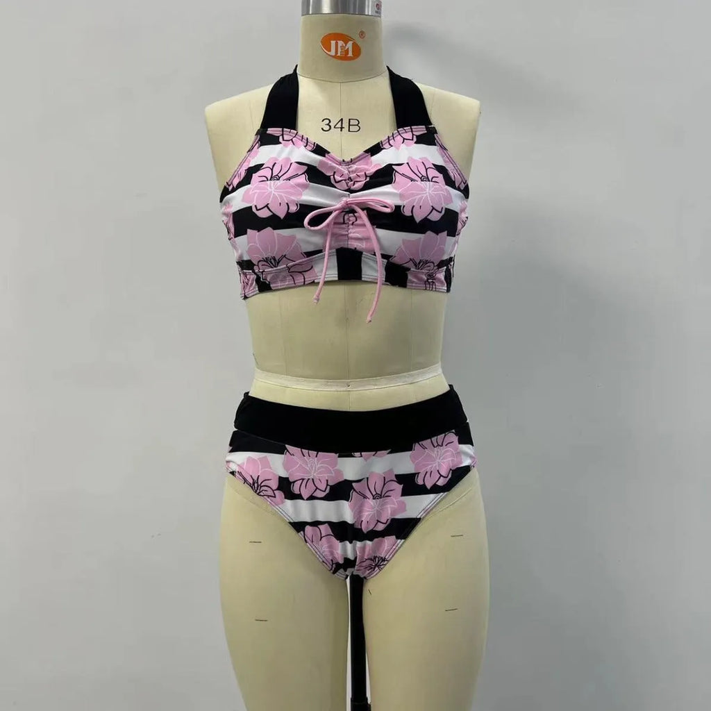 Black women's bikini with printed design, belly coverage and split leg style for swimming.