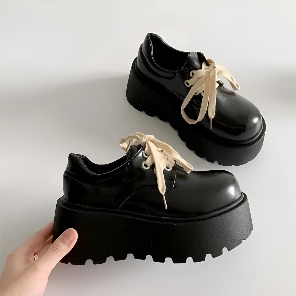 Women's matte black retro chunky sole lace-up ankle boots with a round toe on a white background.
