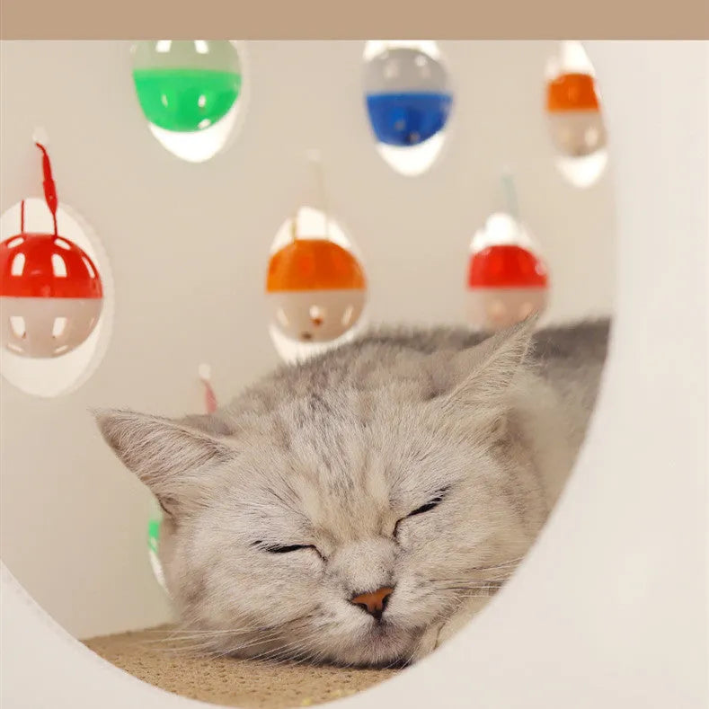Integrated plastic cat scratch board with attached nest, tunnel, and a bell ball toy.