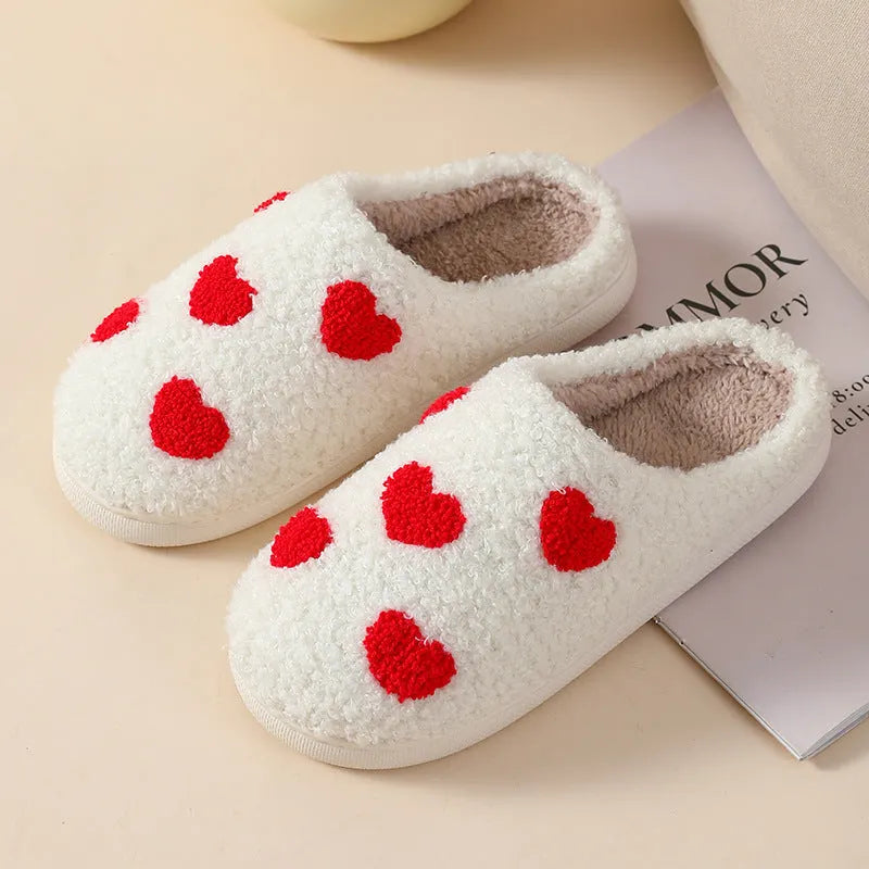 Plush cartoon love style slippers for women with non-slip PVC soles in multiple colours.