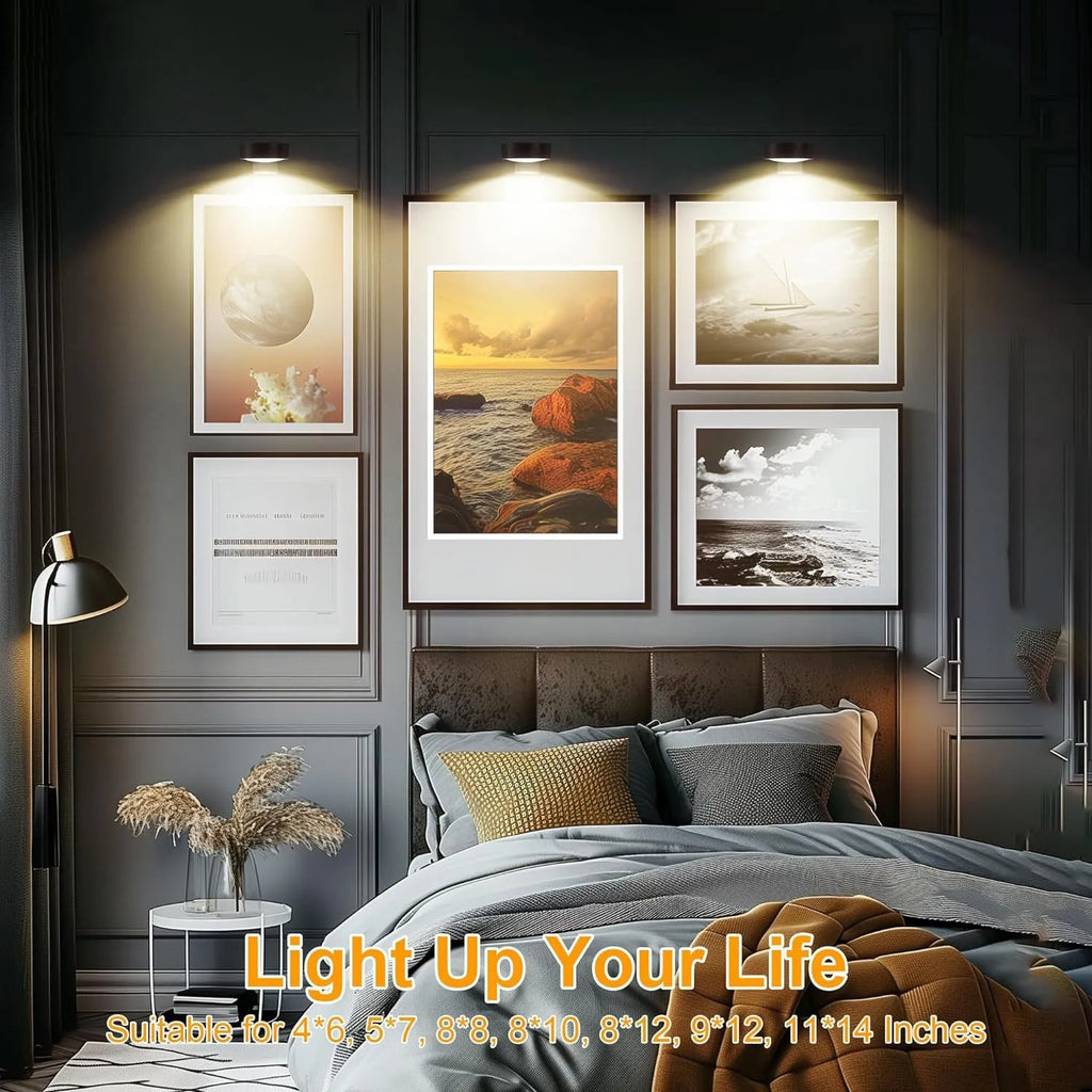 Wireless magnetic LED picture light with remote control in black, mounted on a painting frame.