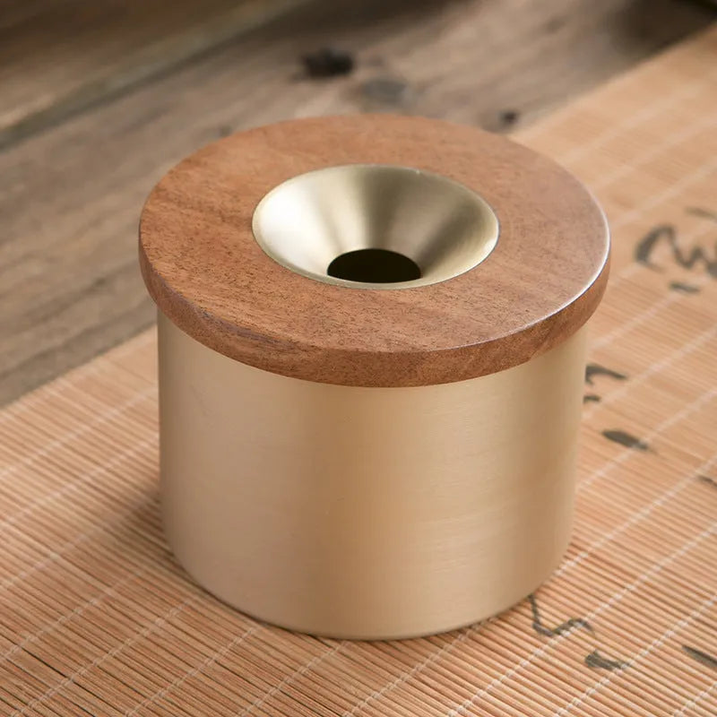 Retro brass-coloured copper ashtray with a wooden lid featuring a central hole