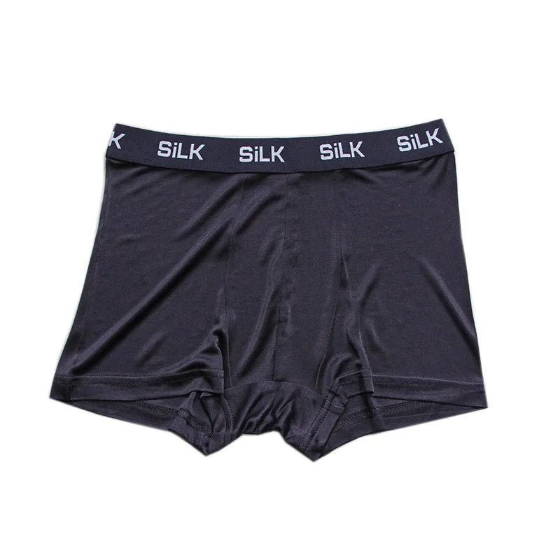 Men's loose fit silk shorts in navy blue showing mid waist design and breathable fabric