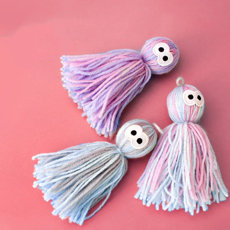 Wool cat toy ball with hanging string in blue grey, pink and blue, or pink purple colours for biting and scratching