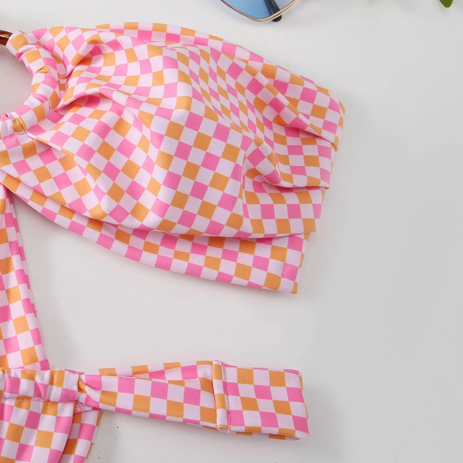 Women's floral printed tube top ring bikini swimsuit on a neutral background.