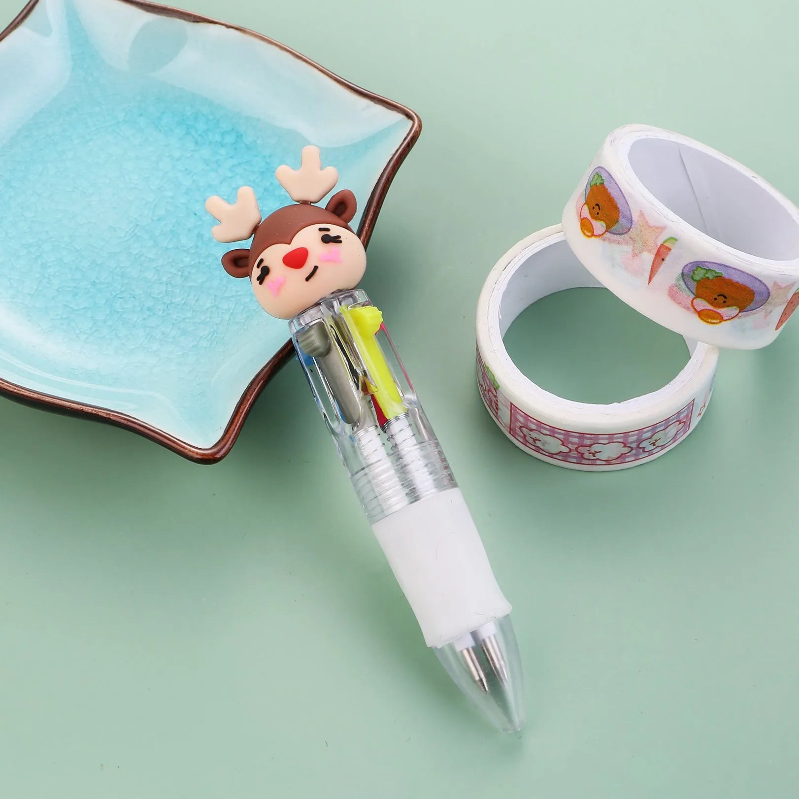 Christmas mini four-colour press-type ballpoint pen showing festive designs, 11cm long.