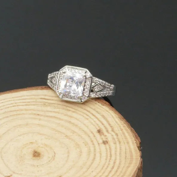 Women's geometric zircon ring with platinum finish on a copper band, showing hollow construction and quadrilateral design.