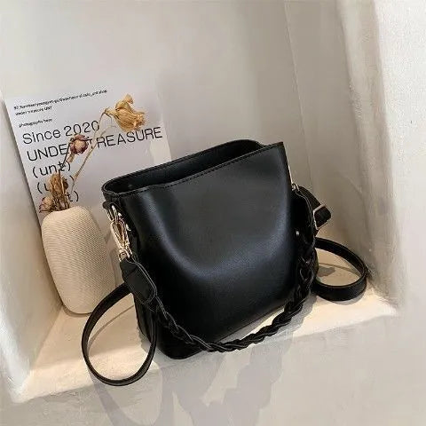 Unisex khaki PU leather crossbody bucket bag with woven texture and one shoulder strap.