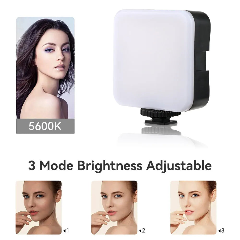 Small square LED camera flash on a mini tripod, showing rotatable head and compact size.