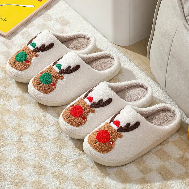 Pair of red Christmas elk plush home slippers on floor, soft anti-slip shoe design