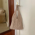 Women's crochet knitted shoulder tote bag in a solid colour with hollow retro design and double straps.