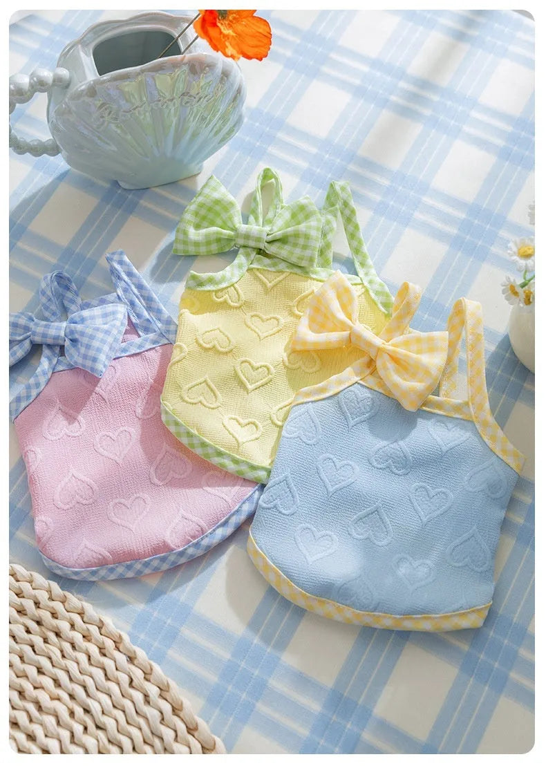 Small dog wearing heart pattern bow suspenders vest with matching hairband in Bondi Blue colour