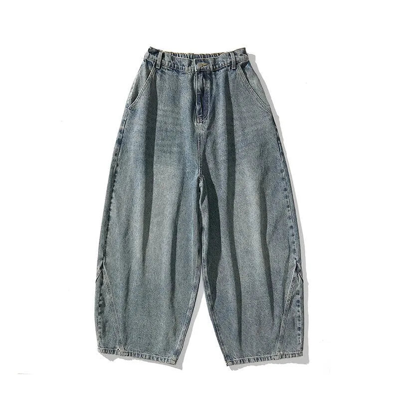 Men's loose-fit straight leg jeans in black denim on a hanger.