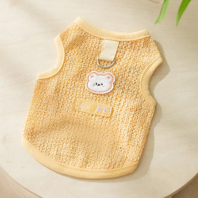 Green knitted cat clothing with a bear patch, showing hollowed-out breathable fabric.