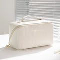 Vertical pattern pillow makeup bag in PU leather showing cubic shape and large storage capacity