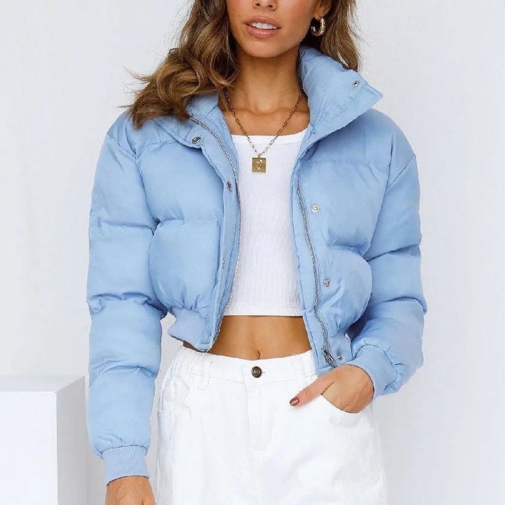 Loose fit blue polyester jacket for women on a hanger, showing long sleeves and front closure.