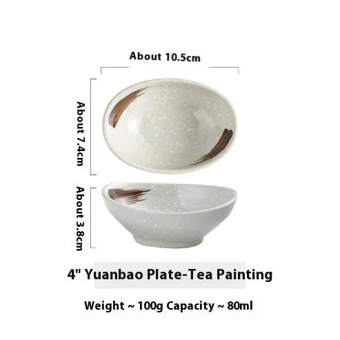 Oval Japanese ceramic sauce dipping bowl with traditional underglaze pattern on a wooden table.