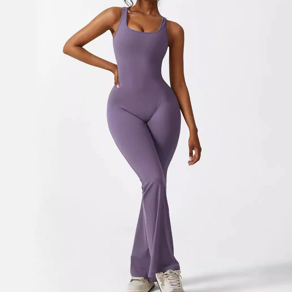 Woman wearing a sleeveless army green flare jumpsuit for yoga, demonstrating the high-elasticity polyester fabric.