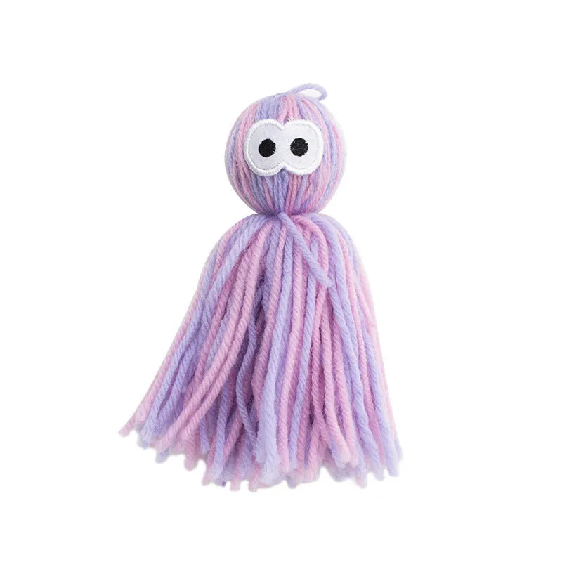 Wool cat toy ball with hanging string in blue grey, pink and blue, or pink purple colours for biting and scratching