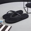 Green rubber flip-flop with fish label design, showing textured non-slip sole.