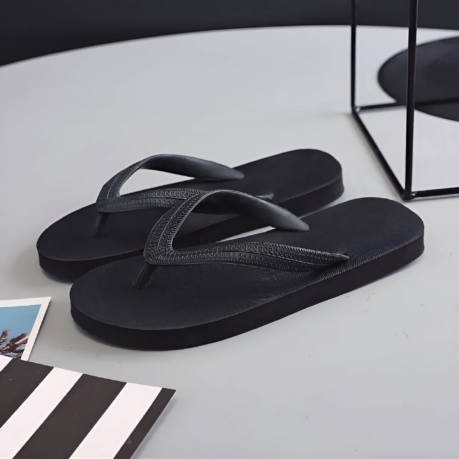 Green rubber flip-flop with fish label design, showing textured non-slip sole.