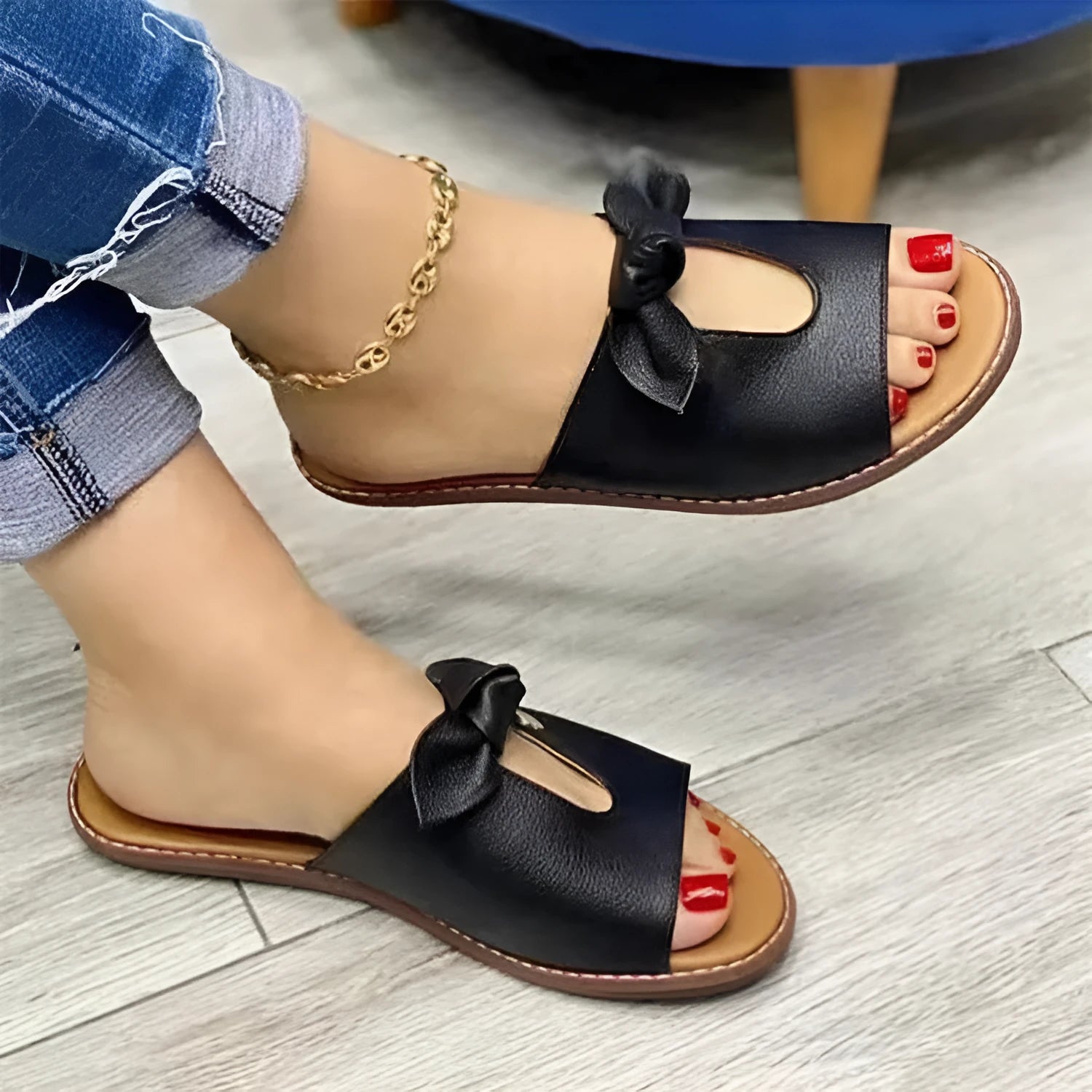 Ladies' black sandals with a fish mouth toe design and a decorative bow on the strap.