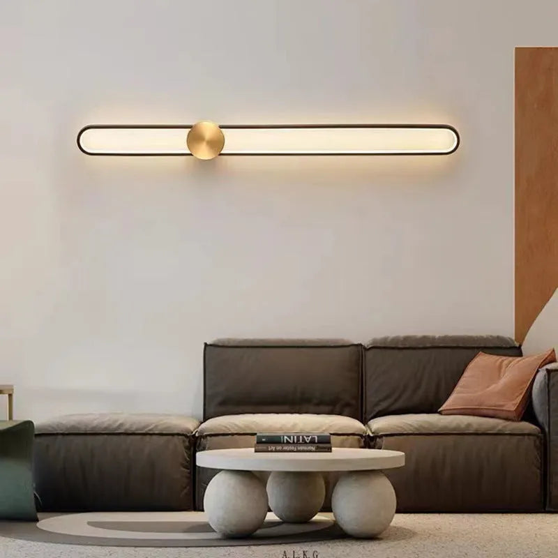 Round modern minimalist wall lamp with iron shade in black or gold finish.