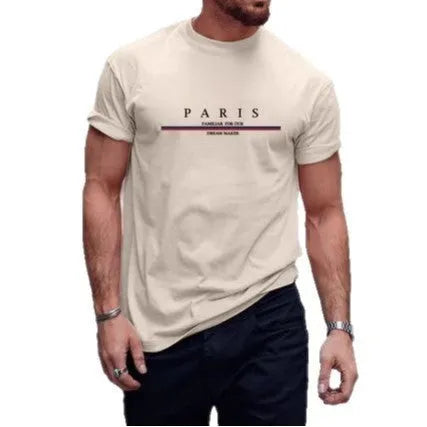 Man wearing a loose fit apricot coloured short-sleeved T-shirt with a black letter print on the front.
